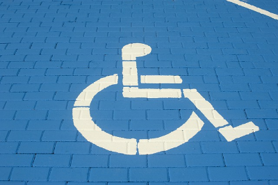 handicap symbol painted in white on a blue brick background